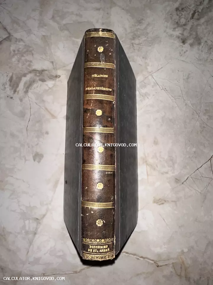 Вид сверху на корешок старинной книги с золотым тиснением и надписями Mélanges Phalanstériens и Donnedieu de St. André.