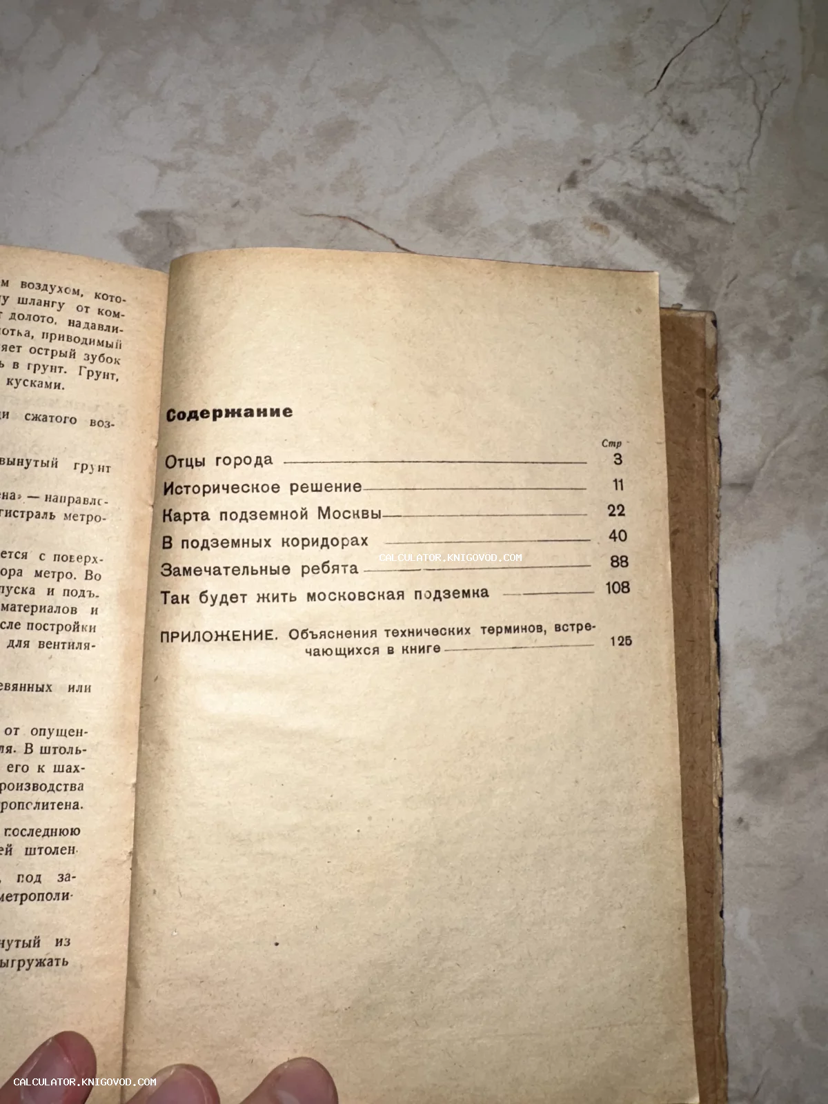 Фотография открытой старой книги на странице с оглавлением, содержащим главы о строительстве московской подземки.