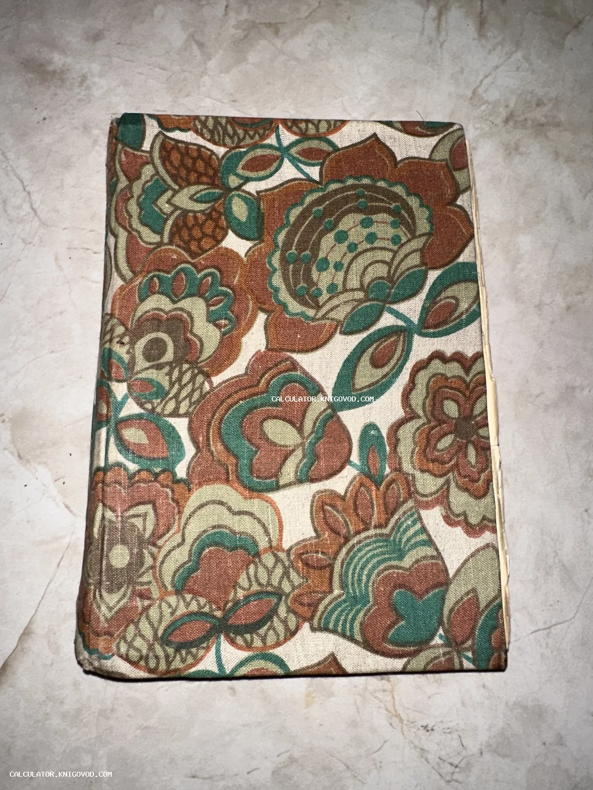 Книга в плотном тканевом переплете с крупным цветочным принтом в коричневых, зеленых и бежевых тонах.