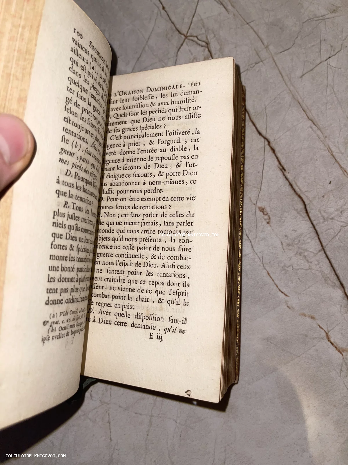 Разворот антикварной книги на французском языке с текстом о Молитве Господней на пожелтевшей бумаге.