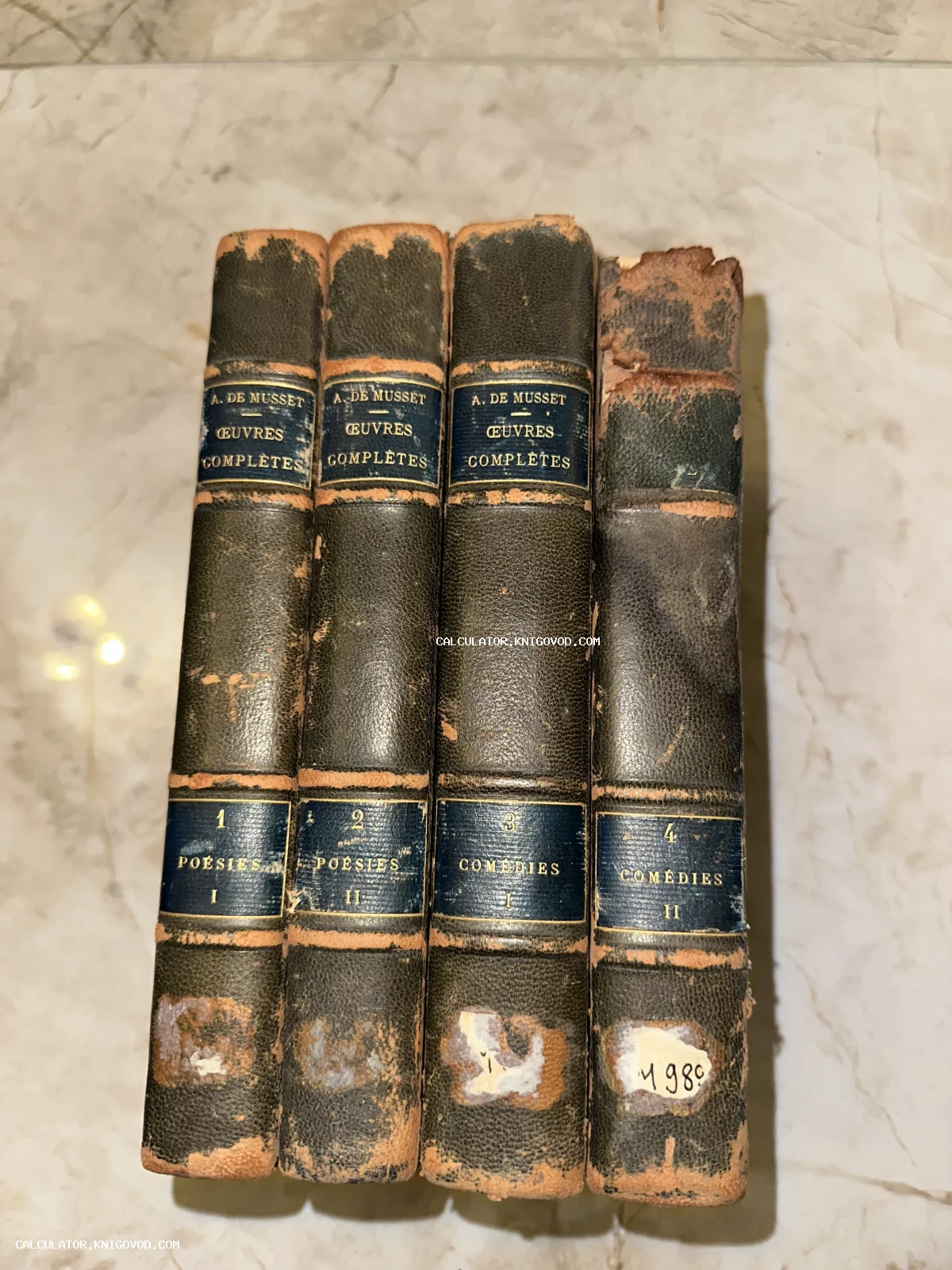 Четыре старинных тома в темных кожаных переплетах с золотым тиснением на корешках, автор Альфред де Мюссе.
