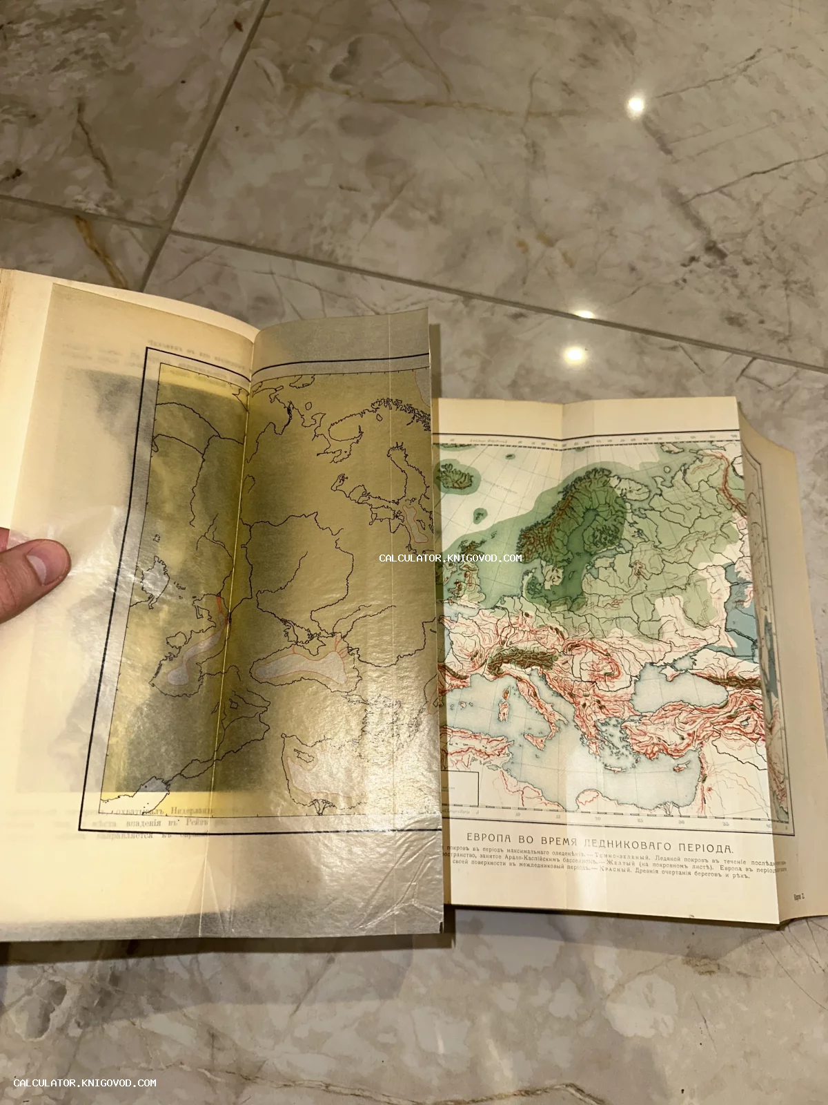 Разворот старинной книги с цветной картой Европы ледникового периода и полупрозрачной калькой с контурами.